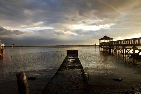 Sunsetting at a lonely pierの写真素材