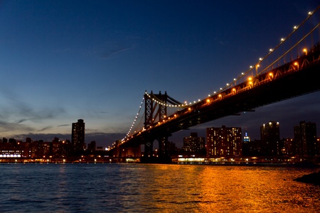 The Williamsburgh bridge view at night from Brooklyn with the Empire State building in the backgroundの写真素材
