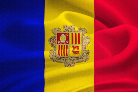 flag of Andorra  waving in the wind. Silk texture patternの写真素材