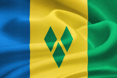  flag of Saint Vincent and the Grenadines waving in the wind. Silk texture patternの写真素材
