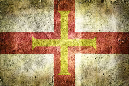 Flag of Guernsey. Old vintage paper texture.の写真素材