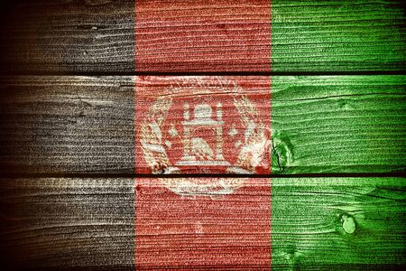 flag of Afghanistan painted on old grungy wooden  backgroundの写真素材