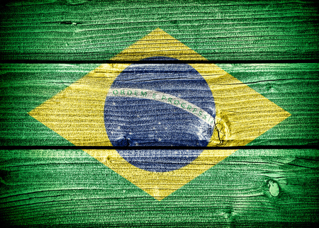 flag of Brazil painted on old grungy wooden  backgroundの写真素材