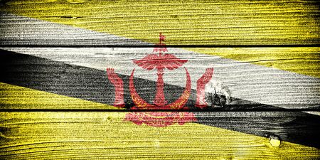 flag of Brunei painted on old grungy wooden  backgroundの写真素材