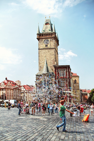 PRAGUE, CZECH REPUBLIC - JUNE 06, 2016: Unidentified young man makes soap bubbles in Old Town Square (Staromestske namesti) in Prague, Czech Republic. Prague historical centre has an area of 866 hectares and was added to the list of UNESCO World Heritage のeditorial素材