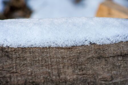 snow on a piece of treeの写真素材