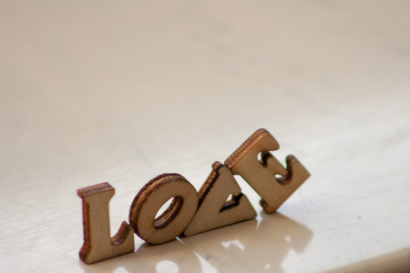 The word 'love' made of wooden letters. wood inscription on white backgroundの写真素材