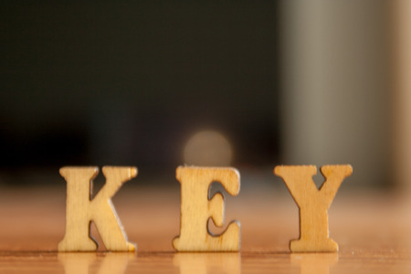 The word 'key' made of wooden letters. wood inscription on tableの写真素材