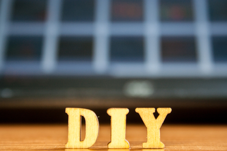 The word 'diy' made of wooden letters. wood inscription on tableの写真素材
