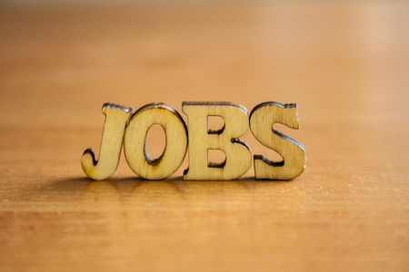 The word 'jobs' made of wooden letters. wood inscription on tableの写真素材