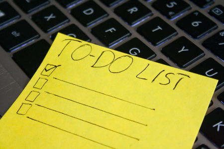 To do list on yellow card. Checklist on keyboard background.の写真素材