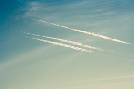 Streaks in the blue sky after flying planes