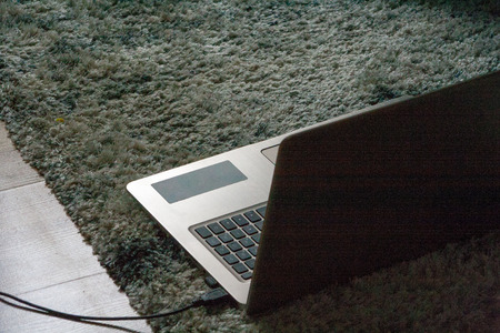 A modern laptop on the carpetの写真素材