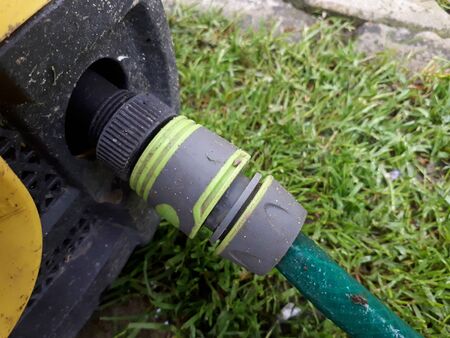 Plastic hose connector connected to a pressure washer.の写真素材
