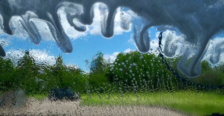 Close-Up Of Car Being Washed. Wet car. Washing foam on car window. Car wash abstract background.