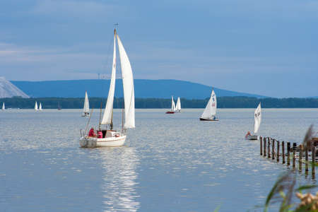 September 2, 2018 - Steinhude, Germany. Small white boat sailing on the lakeのeditorial素材