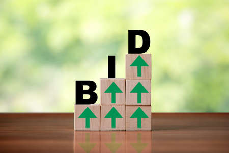 Wooden cube block shapes as step stairs with BID wordの写真素材