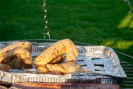 meat from chicken and pork on barbecue grill cooked for summer family dinner