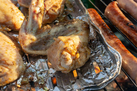 meat from chicken and pork on barbecue grill cooked for summer family dinner