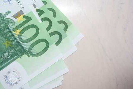 Green 100 euro banknote on table. Half photo copy spaceの写真素材