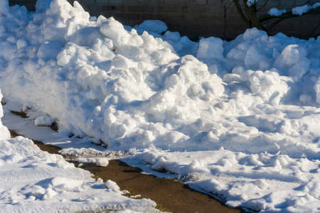 Heavy and heavy snowfall. Weather alert. Winter of the century. Heap of white snows outdoorの写真素材