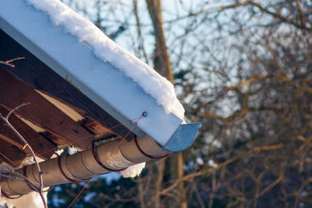 Snow on the roof. Cold temperature. Snow on houseの写真素材