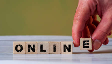 The hand put wooden cube block and creates word ONLINE. Learn and work online during coronavirus time. Internet lesson and coachingの写真素材