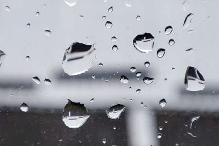 Raindrops on a window background in a rainy day