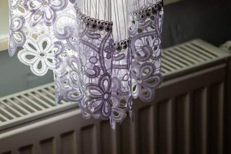 Part of a white frill curtain at home. Interior with a white curtain. Modern curtain closeupの写真素材