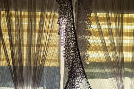 Part of a white frill curtain at home. Interior with a white curtain. Modern curtain closeupの写真素材