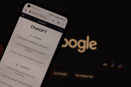 Warsaw Poland - February 24, 2023: OpenAI ChatGPT vs Google concept. Chat bot GPT on smartphone and Google logo backgroundのeditorial素材