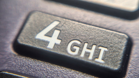 Close-up view of a mobile phone keypad showing the number four alongside the letters GH and I. This...