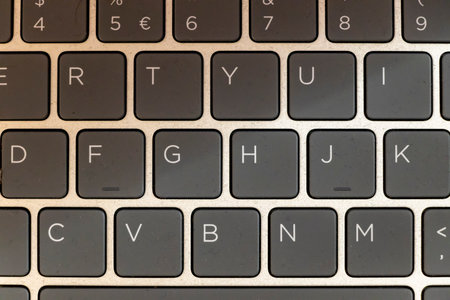Close-up view of a modern keyboard showing the keys used for typing. Ideal for technology business and education topics in various contexts.の写真素材