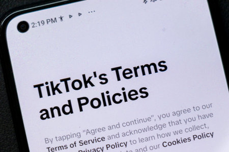 Warsaw Poland - September 24 2025: Close-up of a smartphone screen displaying TikToks terms and policies emphasizing user agreement and privacy information.のeditorial素材