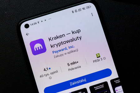 Warsaw Poland - September 24 2025: A close-up of a smartphone screen displaying the Kraken app showcasing cryptocurrency purchasing options and user ratings.のeditorial素材