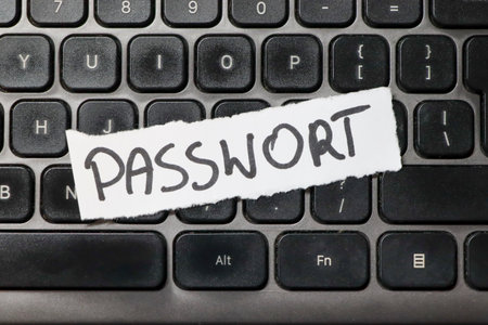 A close-up view of a computer keyboard featuring a handwritten note that reads PASSWORD. This image...