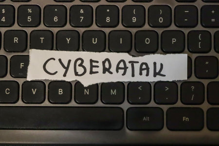 Handwritten note reading CYBERATAK on a computer keyboard symbolizes cyber threats and online...