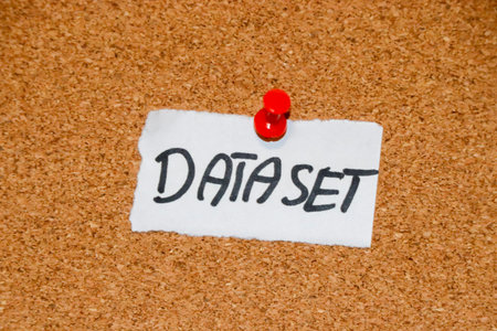 A handwritten note saying DATASET pinned to a corkboard illustrating the concept of data collection. This image can be used in technology or educational contexts.の写真素材