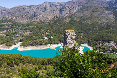 A breathtaking view of Guadalest Spain featuring turquoise water and majestic mountains. This serene landscape showcases the beauty of nature and invites exploration.の写真素材