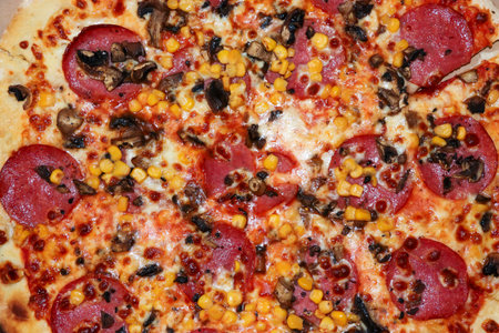 Delicious pizza topped with pepperoni mushrooms and corn showing a mouth-watering blend of flavors...