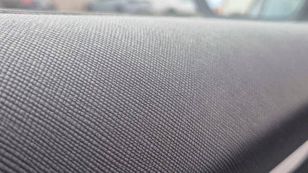 Close-up of textured black fabric interior in a modern car showcasing detailed weave patterns typically used in automotive upholstery for comfort and style.の写真素材