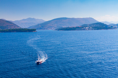 Blue pilot boat approaching on waterwayの写真素材