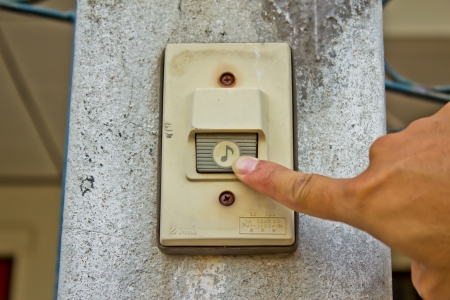 Pushing an electronic doorbellの写真素材