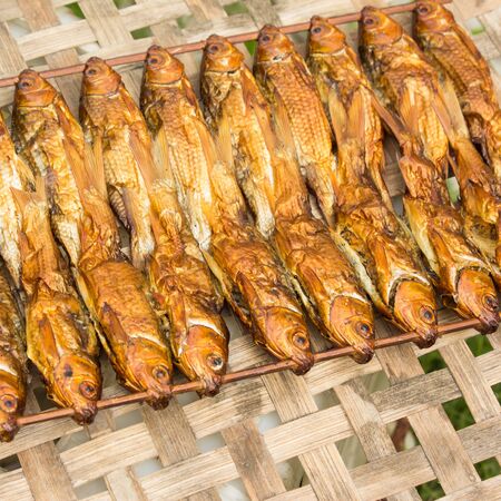 background of golden smoke-dried fish