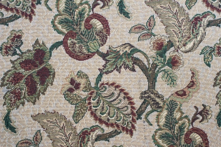 Fragment of colorful retro tapestry textile pattern with floral ornament useful as background