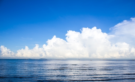 Blue sea and sky with white clouds.の写真素材