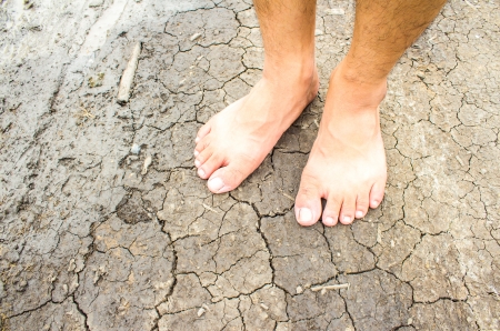 Foot on dry soil texture backgroundの写真素材