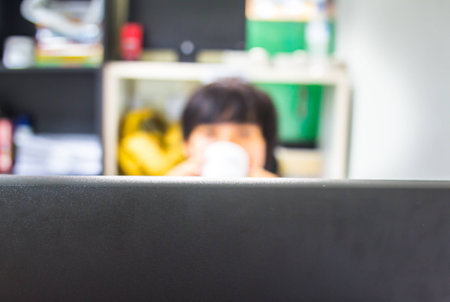 businesswoman drinking coffee and using computerの写真素材
