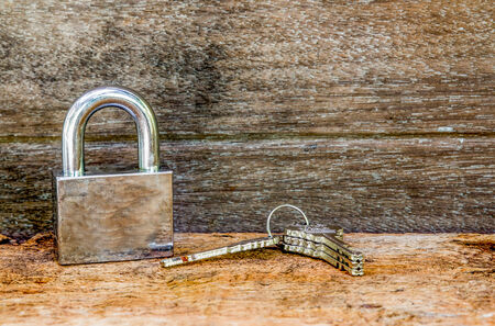 Key and lock on wooden backgroundの写真素材