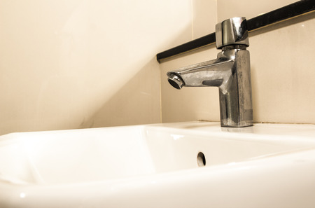 Water drop from faucet by Vintageの写真素材